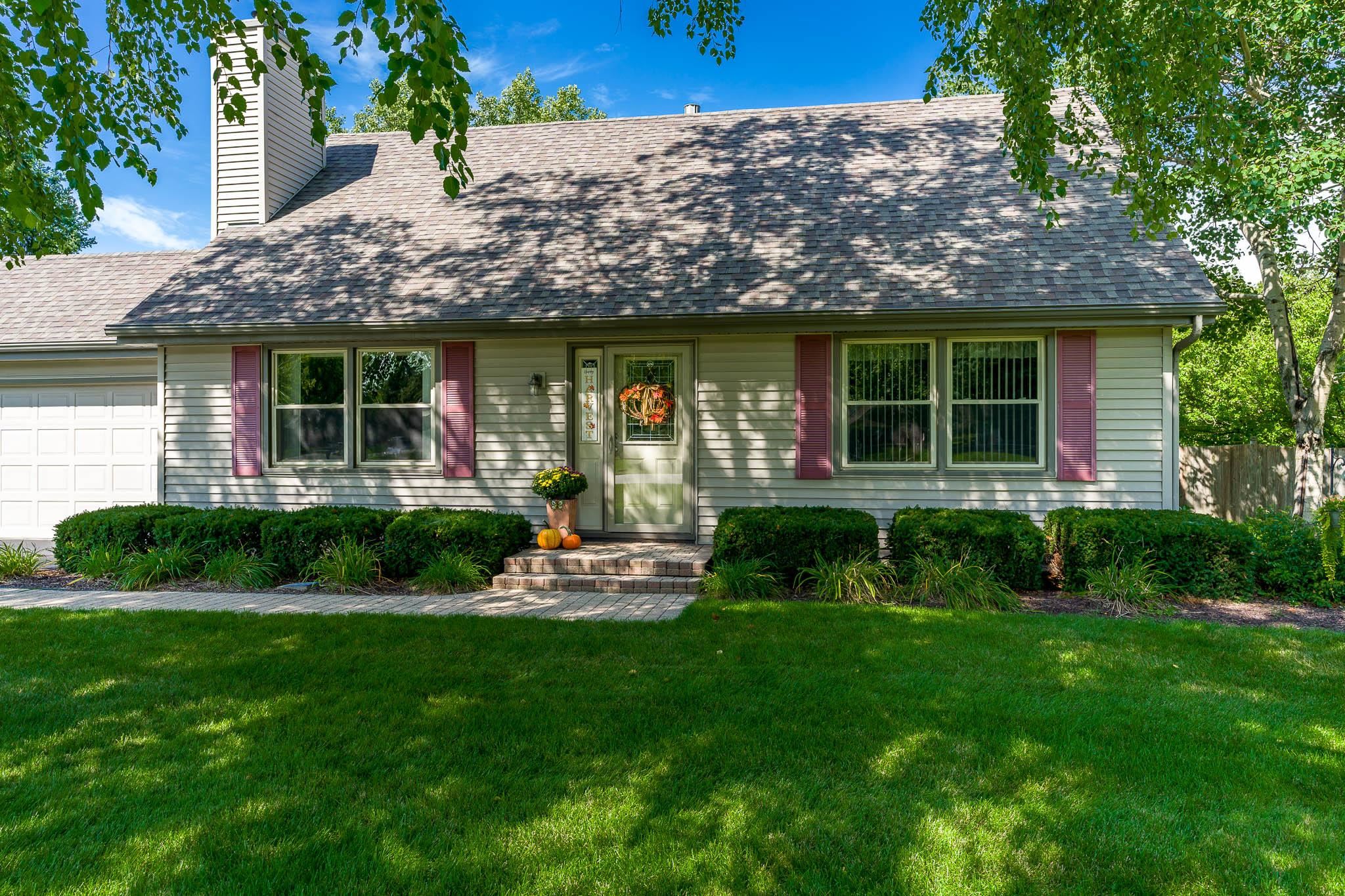 11748 Cedarbrook Road Roscoe, IL 61073 - Photo 3 of 50 a front view of a house with a yard and outdoor seating