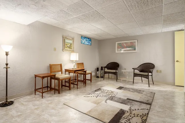 a view of a livingroom with furniture and a window