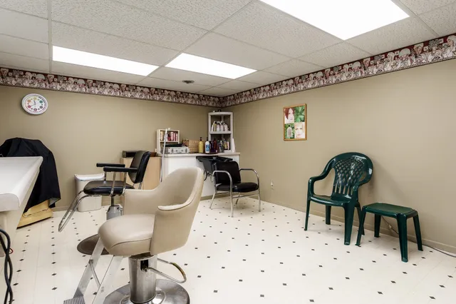a kitchen with a sink a stove and chairs