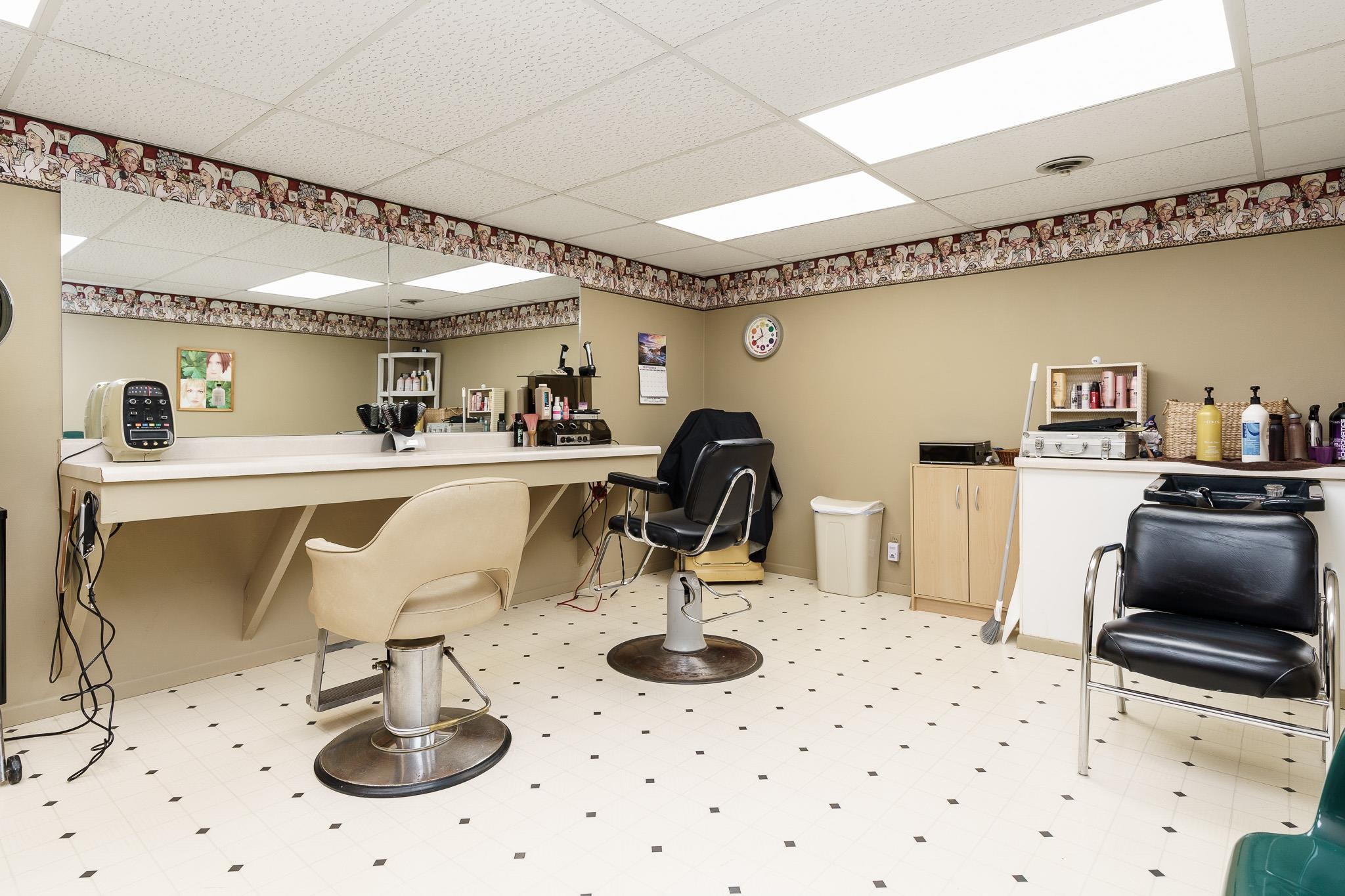 11748 Cedarbrook Road Roscoe, IL 61073 - Photo 36 of 50 a kitchen with a sink a stove and chairs