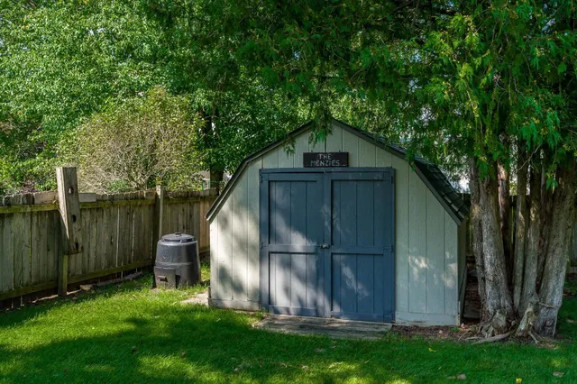 a view of a yard with a fence and trees