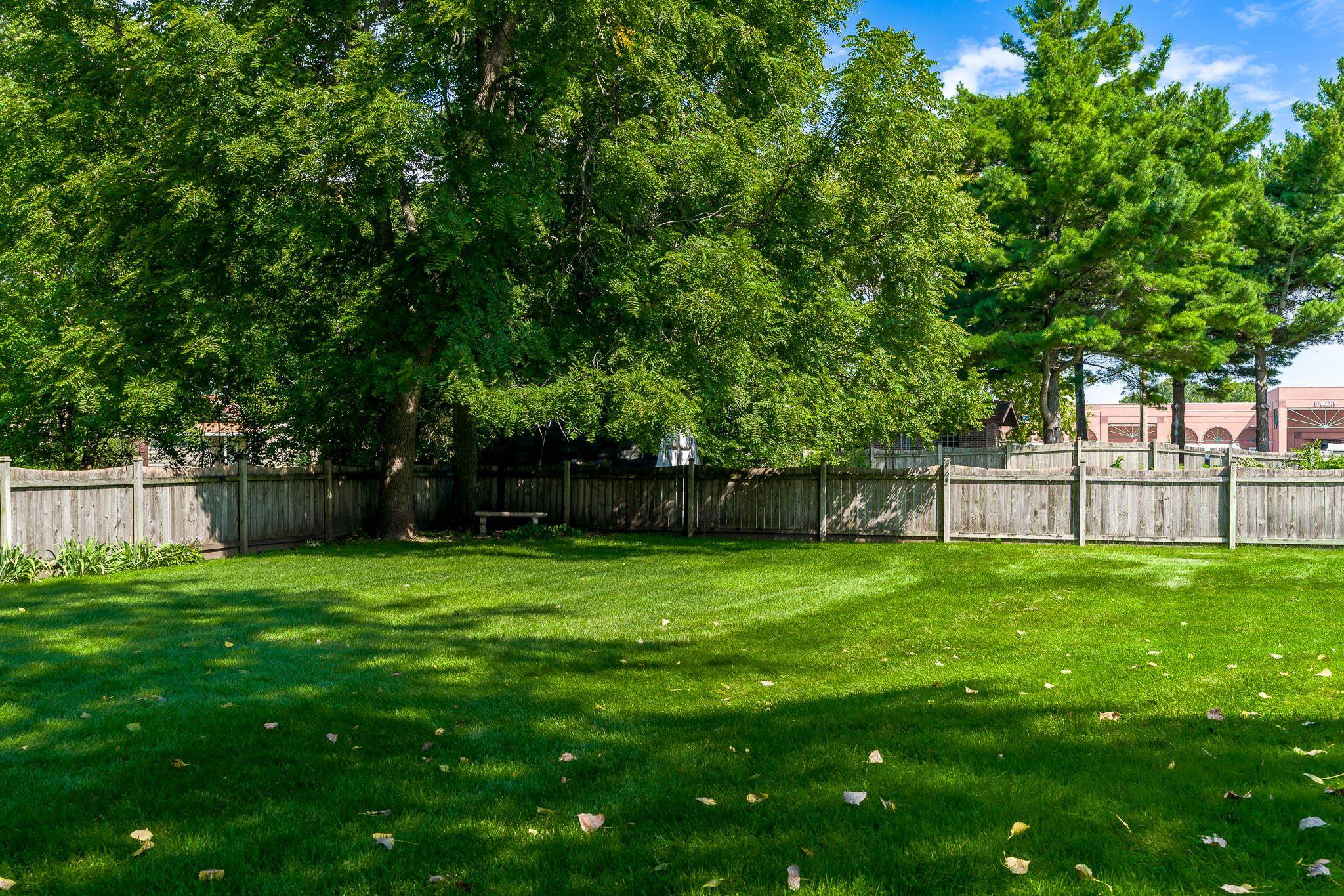 11748 Cedarbrook Road Roscoe, IL 61073 - Photo 45 of 50 a view of a yard with a fence and trees