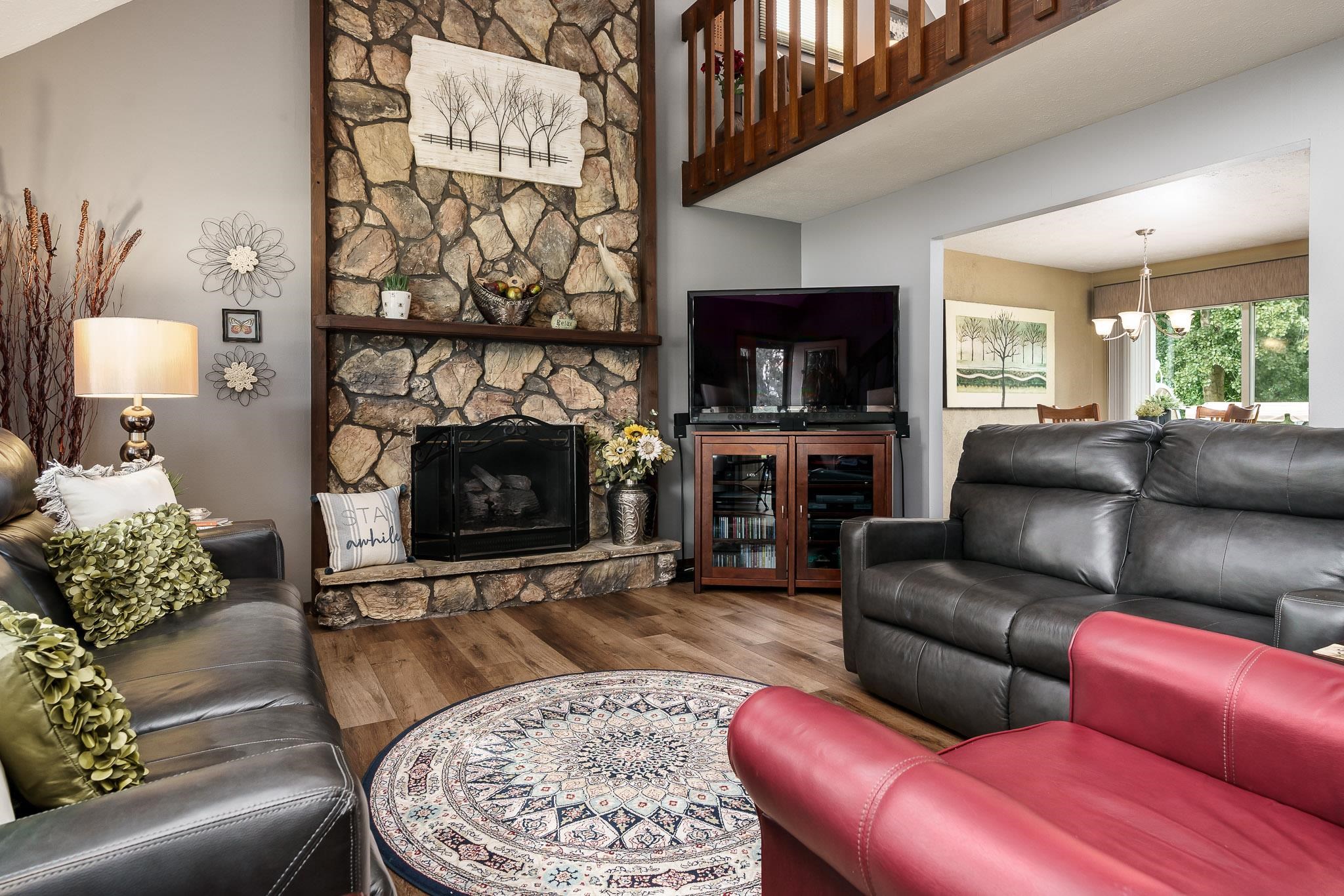 11748 Cedarbrook Road Roscoe, IL 61073 - Photo 6 of 50 a living room with furniture a flat screen tv and a fireplace