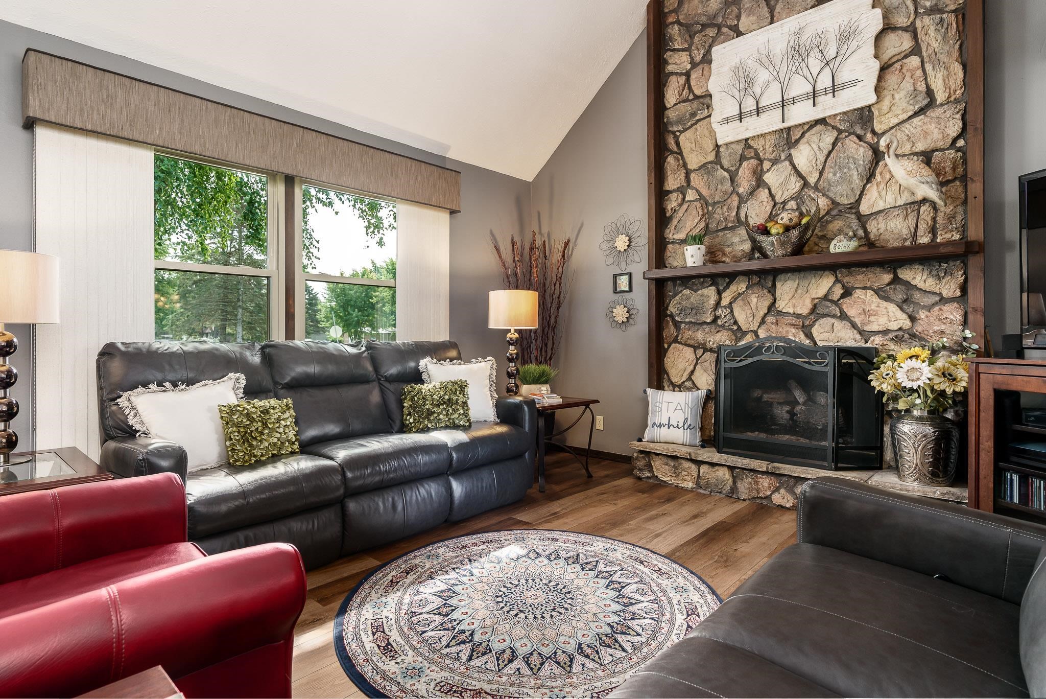 11748 Cedarbrook Road Roscoe, IL 61073 - Photo 7 of 50 a living room with furniture a fireplace and a floor to ceiling window