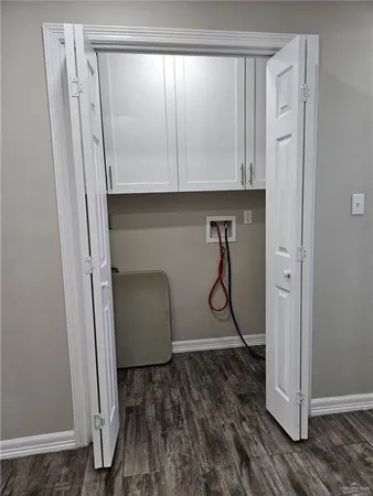 a room with a walk in closet and mirror