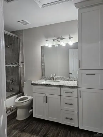 a bathroom with a double vanity sink mirror and toilet