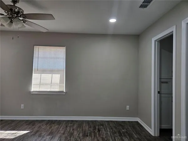 a view of a room with a window and wooden floor