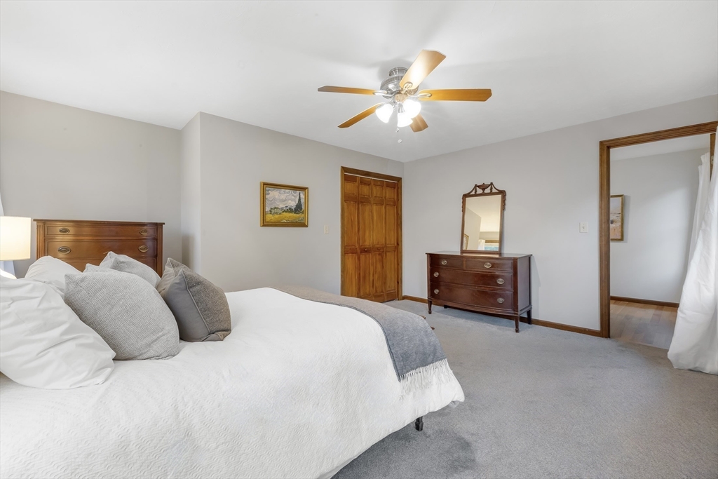 41 Filbert Street Quincy, MA 02169 - Photo 15 of 42 a bedroom with a large bed and a chandelier