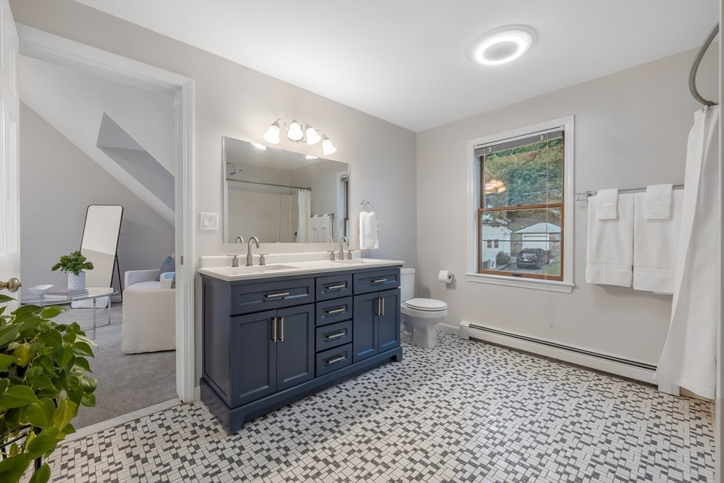 41 Filbert Street Quincy, MA 02169 - Photo 19 of 42 a bathroom with a sink a vanity and a mirror