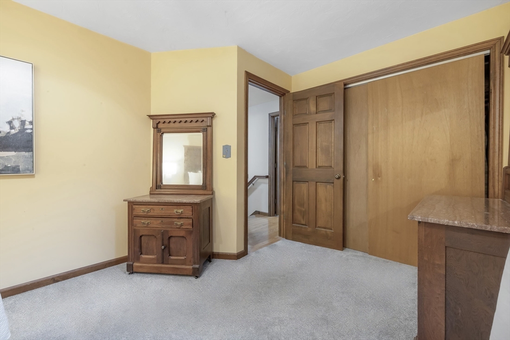 41 Filbert Street Quincy, MA 02169 - Photo 24 of 42 a view of an empty room with wooden floor and a cabinet
