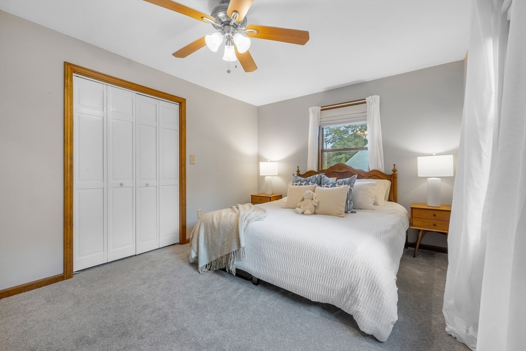 41 Filbert Street Quincy, MA 02169 - Photo 26 of 42 a bedroom with a bed and a chandelier