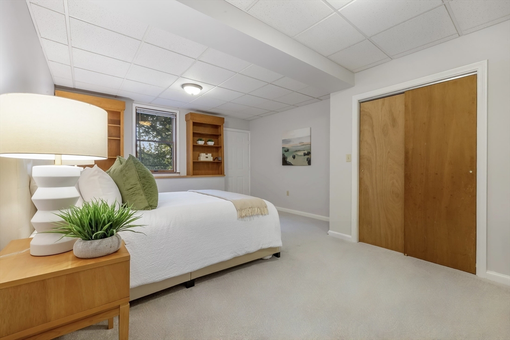 41 Filbert Street Quincy, MA 02169 - Photo 27 of 42 a spacious bedroom with a large bed and a potted plant