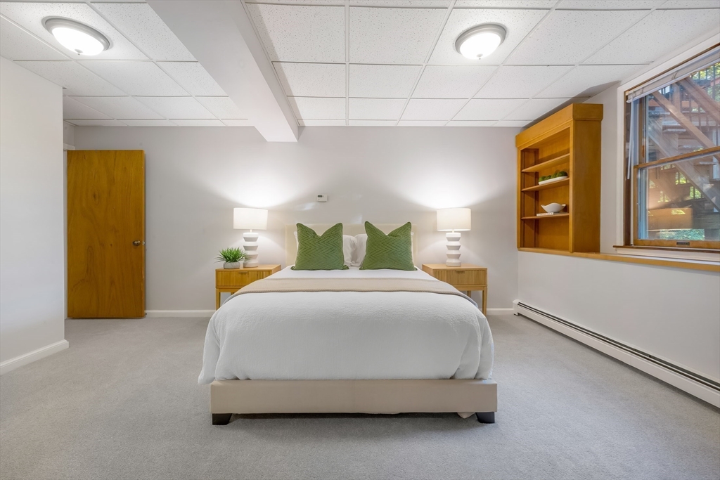 41 Filbert Street Quincy, MA 02169 - Photo 28 of 42 a bedroom with a bed and wooden floor