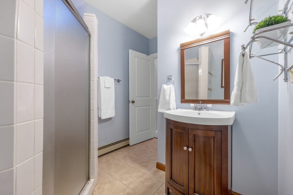 41 Filbert Street Quincy, MA 02169 - Photo 30 of 42 a bathroom with a granite countertop sink and a mirror