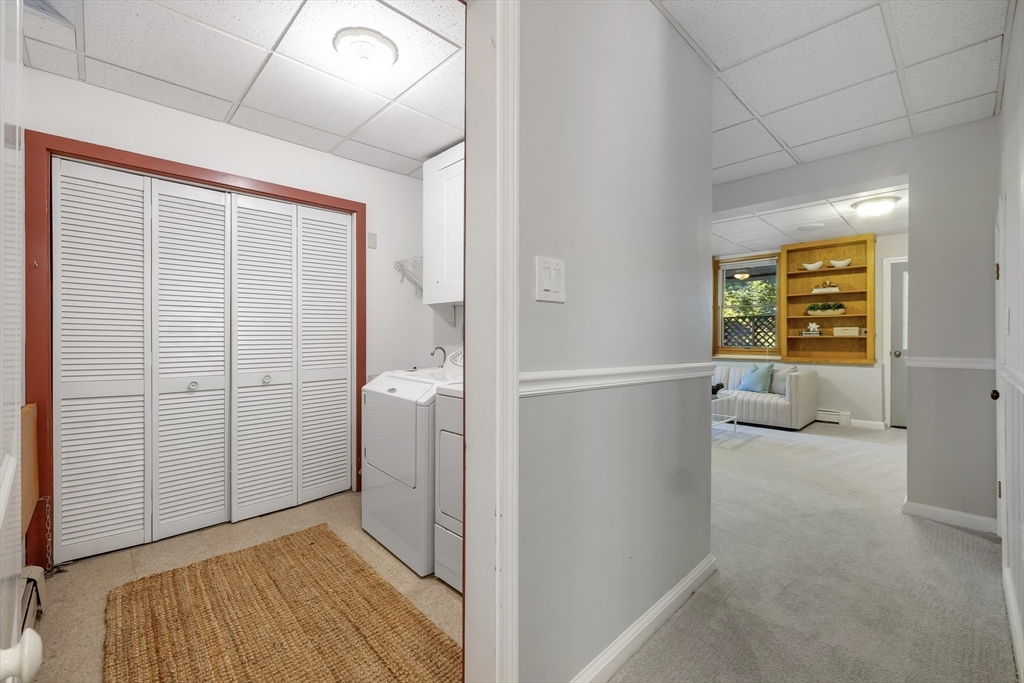 41 Filbert Street Quincy, MA 02169 - Photo 32 of 42 hallway with wooden floor and cabinet