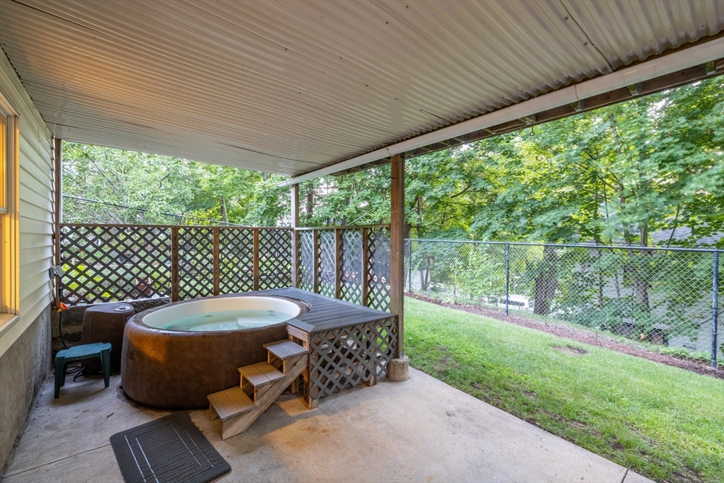41 Filbert Street Quincy, MA 02169 - Photo 36 of 42 a view of a patio with table and chairs with wooden floor and fence