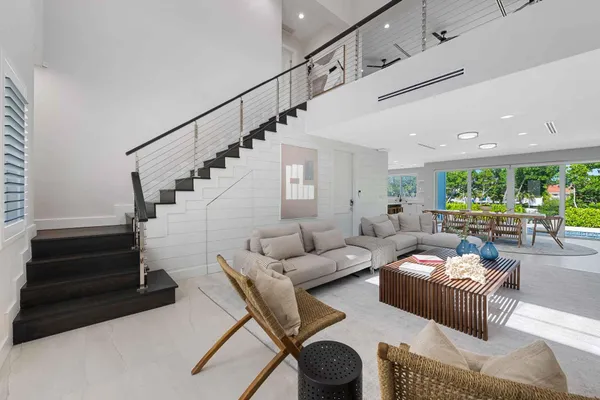 a living room with furniture and stairs