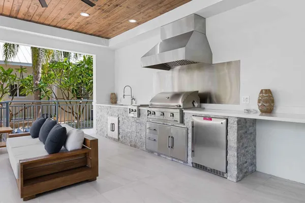 a kitchen with stainless steel appliances granite countertop a sink a stove and a wooden floors
