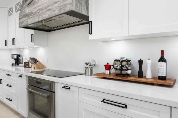 a kitchen with stainless steel appliances white cabinets and a sink
