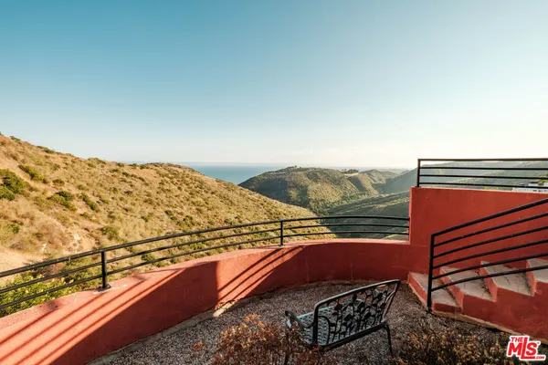 a view of a balcony with an ocean