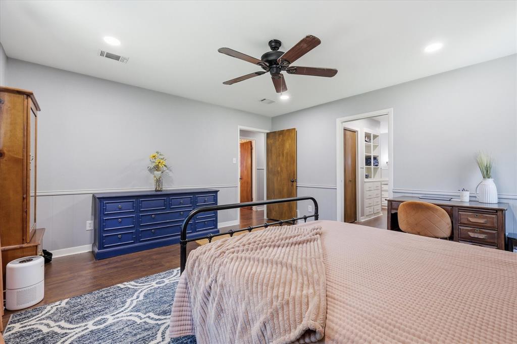 3205 South Garland Street Decatur, TX 76234 - Photo 13 of 30 Interior room featuring wood-finish flooring, light gray walls with chair rail molding, a dark wood-tone ceiling fan, and recessed lighting