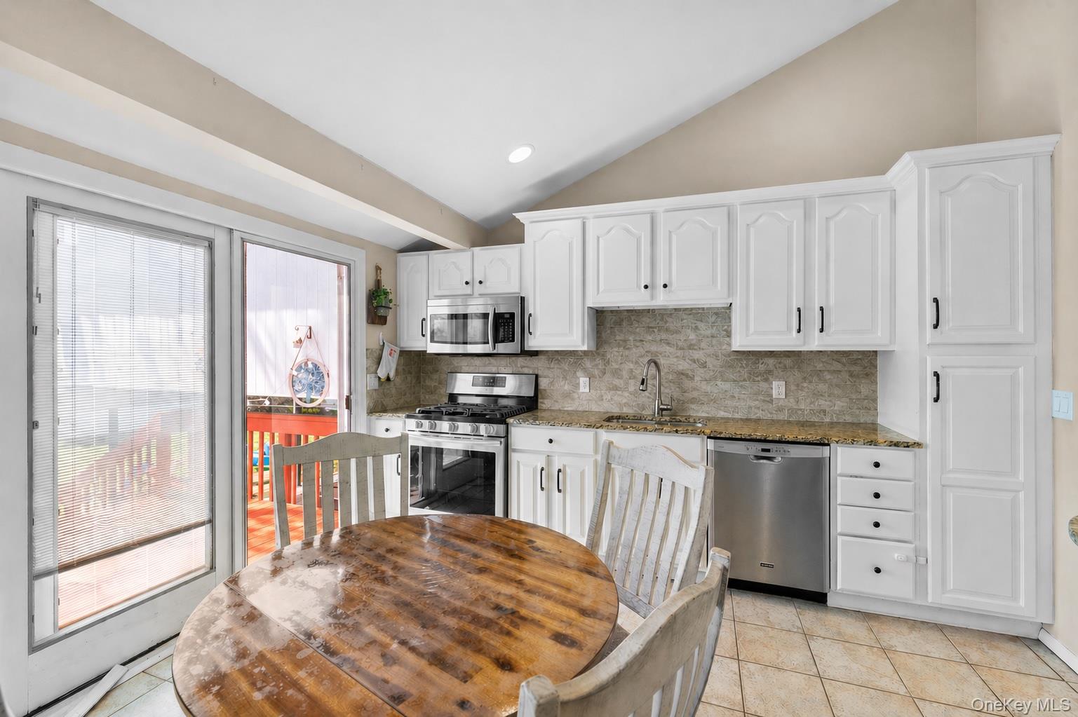 61 Winthrop Road Plainview, NY 11803 - Photo 8 of 37 a kitchen with stainless steel appliances granite countertop a refrigerator sink and stove