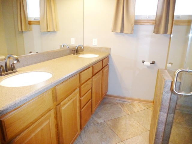 6 Crofton Road Oswego, IL 60543 - Photo 14 of 24 a bathroom with a sink and a mirror