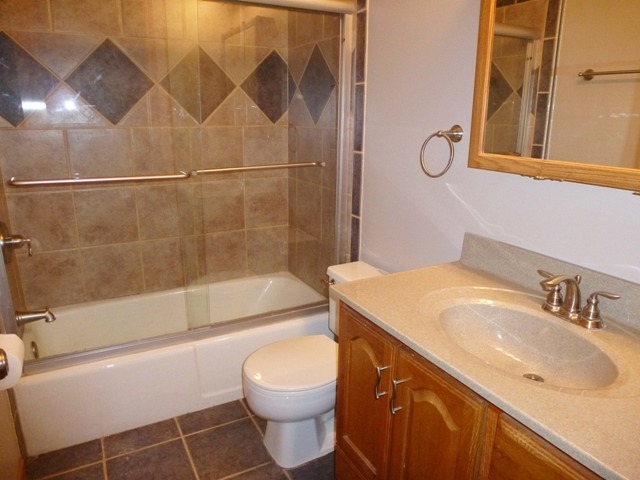 6 Crofton Road Oswego, IL 60543 - Photo 21 of 24 a bathroom with a sink toilet and shower