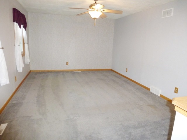 6 Crofton Road Oswego, IL 60543 - Photo 4 of 24 a view of a room with a chandelier fan and wooden floor