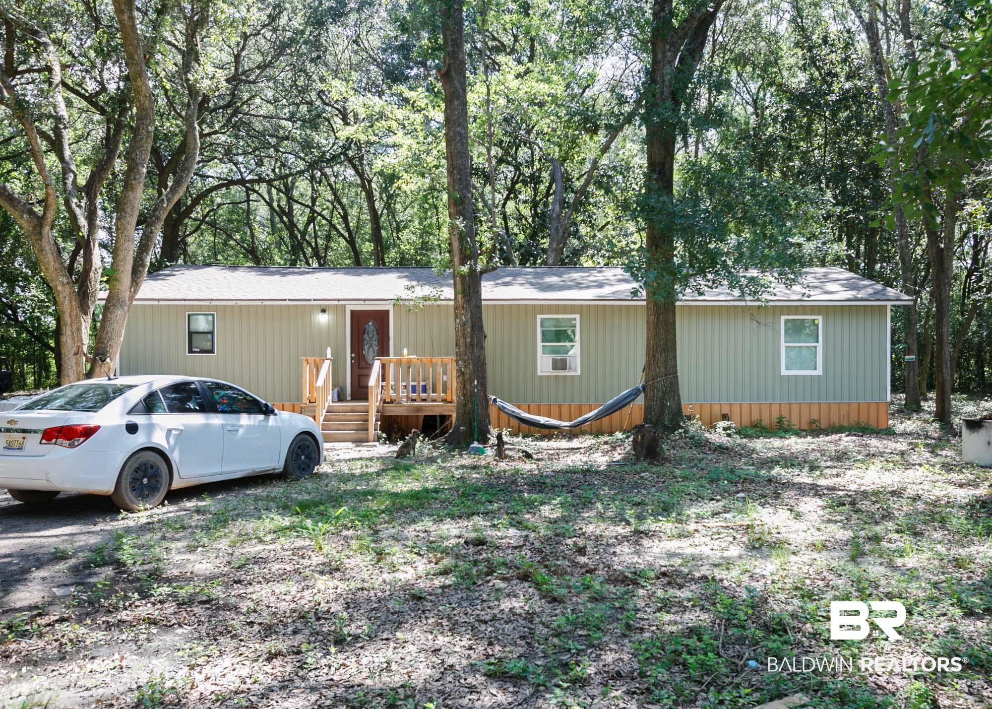 11998 Workman Avenue Foley, AL 36535 - Photo 4 of 59 View of front of property with a wooden deck