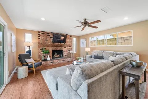 a living room with furniture fireplace and flat screen tv