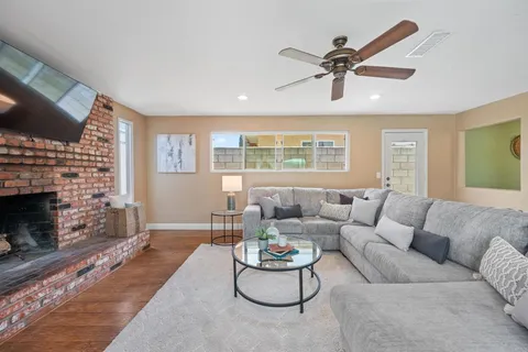 a living room with furniture a fireplace and a flat screen tv
