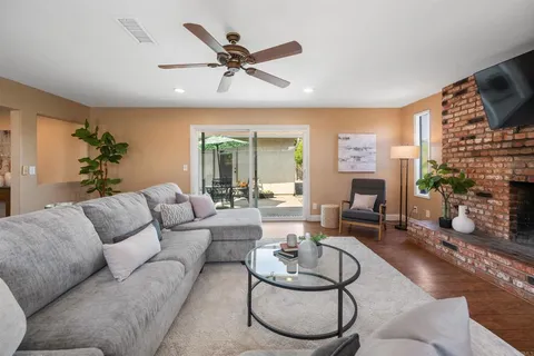 a living room with furniture a fireplace and a flat screen tv