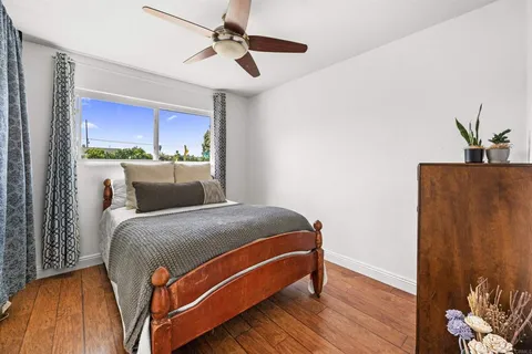 a bed room with a bed and a potted plant