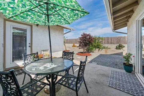 a backyard of a house with table and chairs