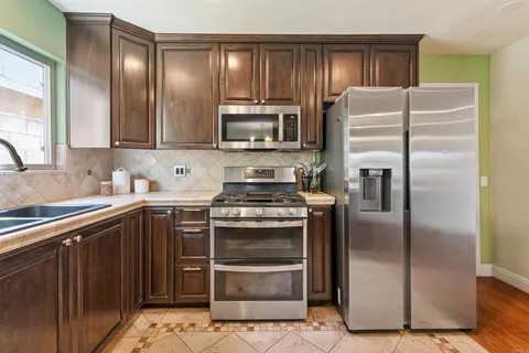 a kitchen with a refrigerator stove and microwave