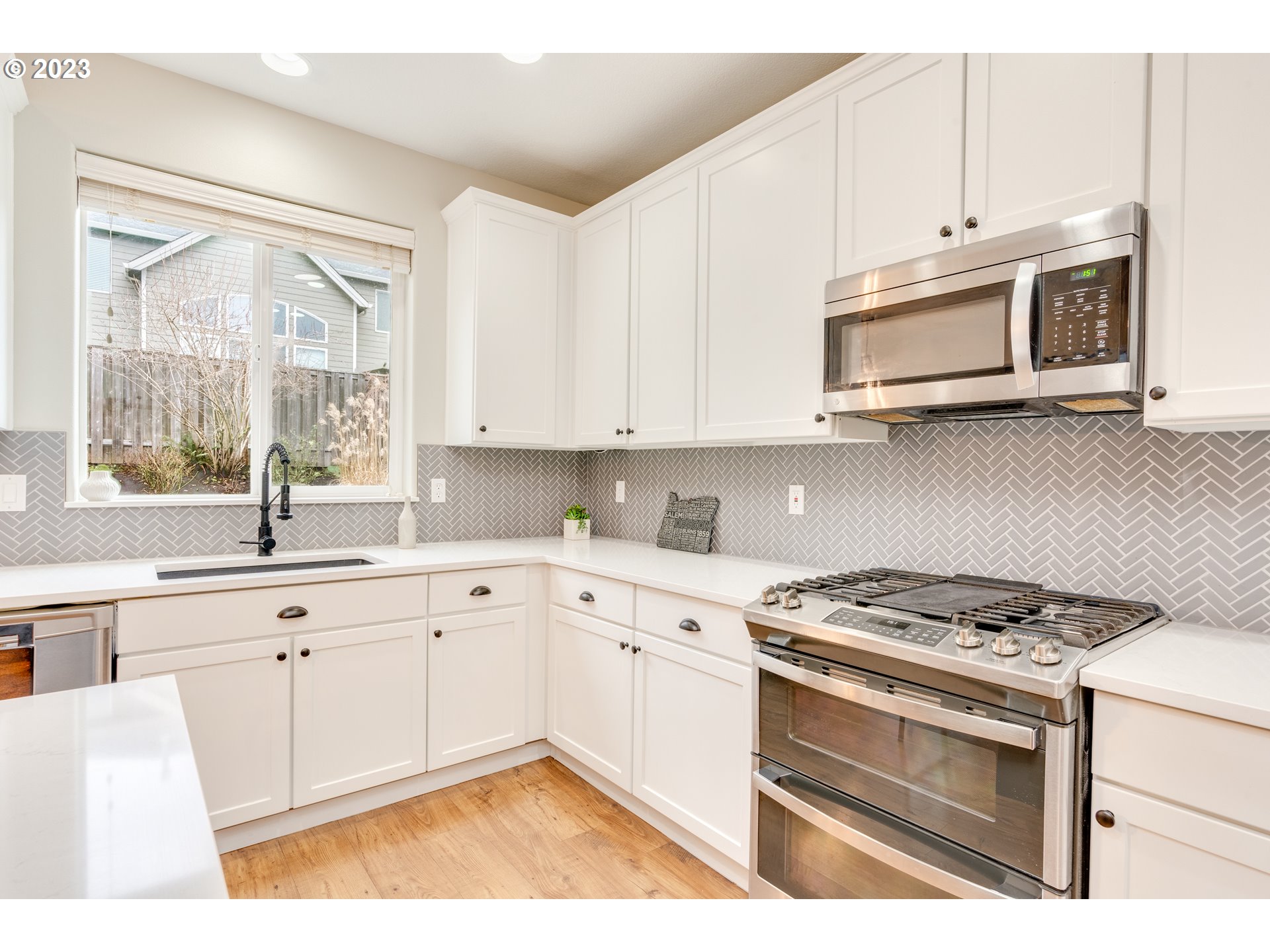 16270 Southeast Jasper Drive Damascus, OR 97089 - Photo 14 of 32 a kitchen with stainless steel appliances white cabinets and a sink
