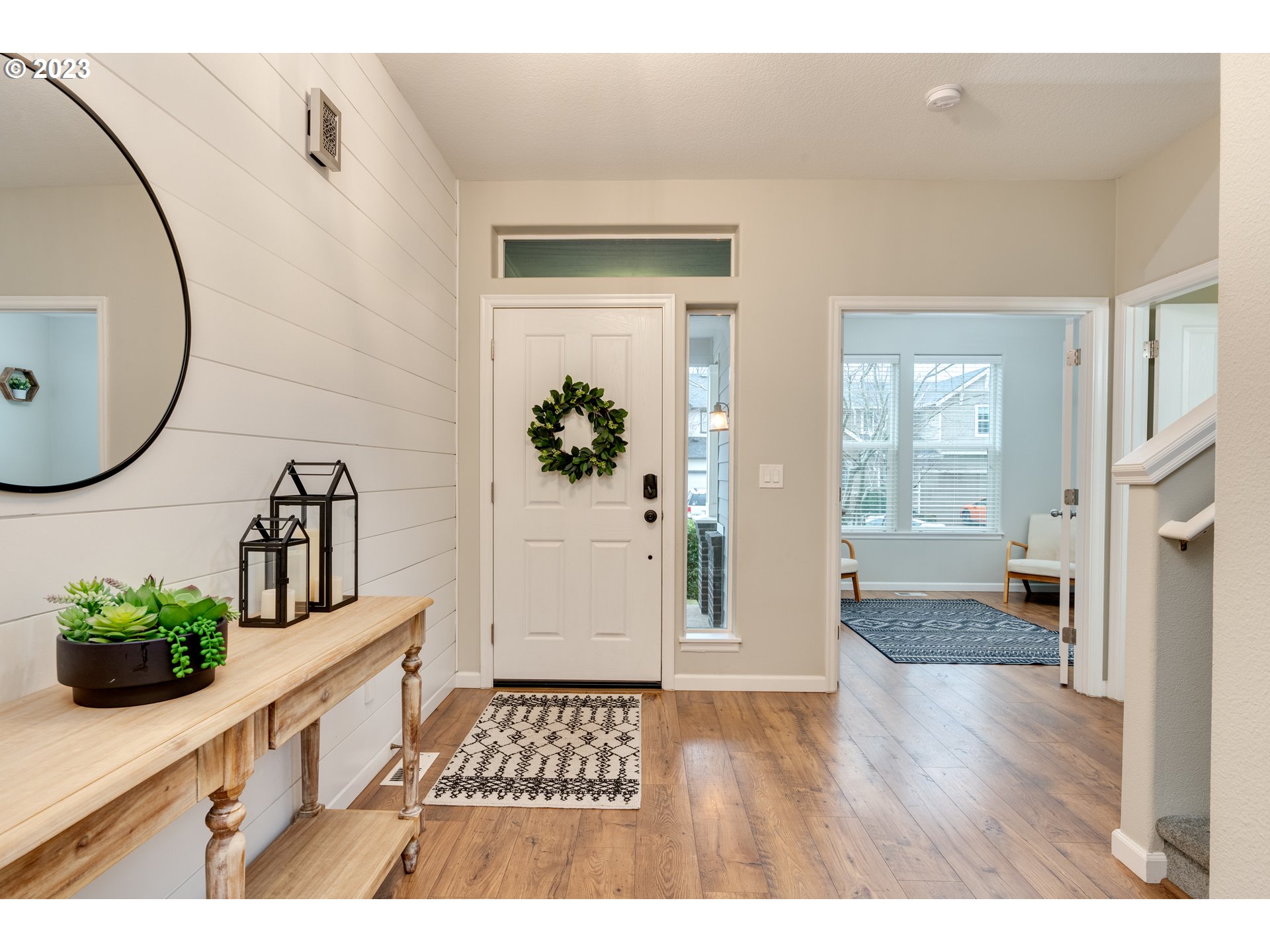 16270 Southeast Jasper Drive Damascus, OR 97089 - Photo 3 of 32 a hallway with wooden floor and a bathroom