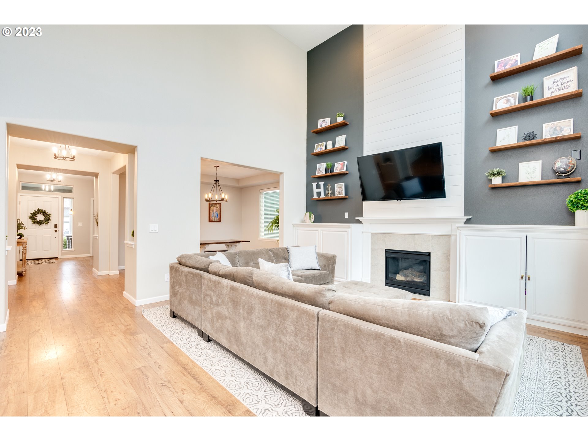 16270 Southeast Jasper Drive Damascus, OR 97089 - Photo 10 of 32 a living room with furniture a flat screen tv and a fireplace