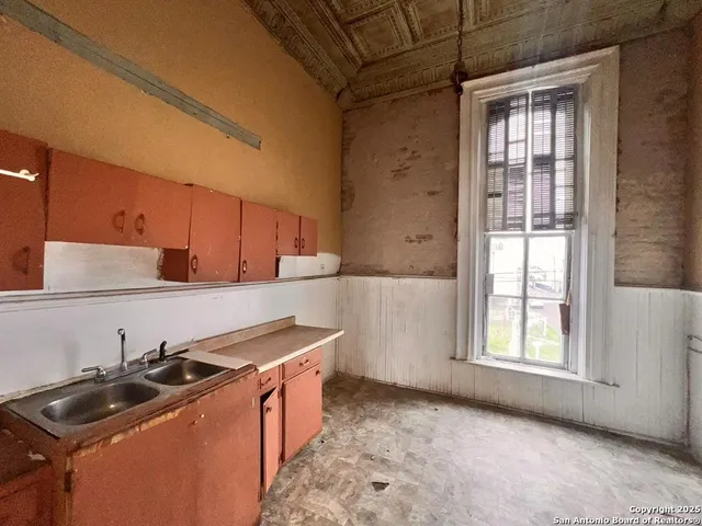 a kitchen that has a sink and a stove