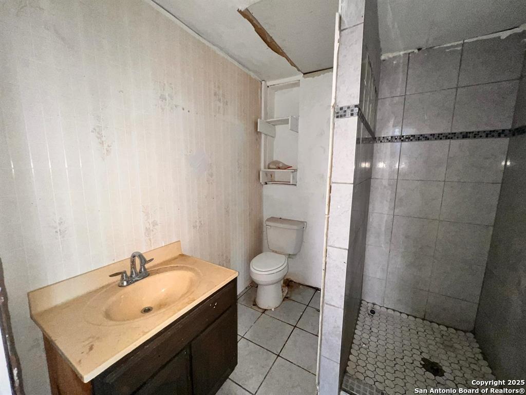 520 Davis Avenue, Unit B Laredo, TX 78040 - Photo 16 of 29 a bathroom with a granite countertop sink toilet and shower