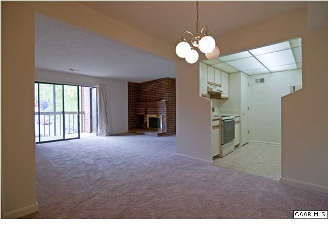 128 Turtle Creek Road, Unit 8 Charlottesville, VA 22901 - Photo 1 of 6 a room with chandelier and wooden floor