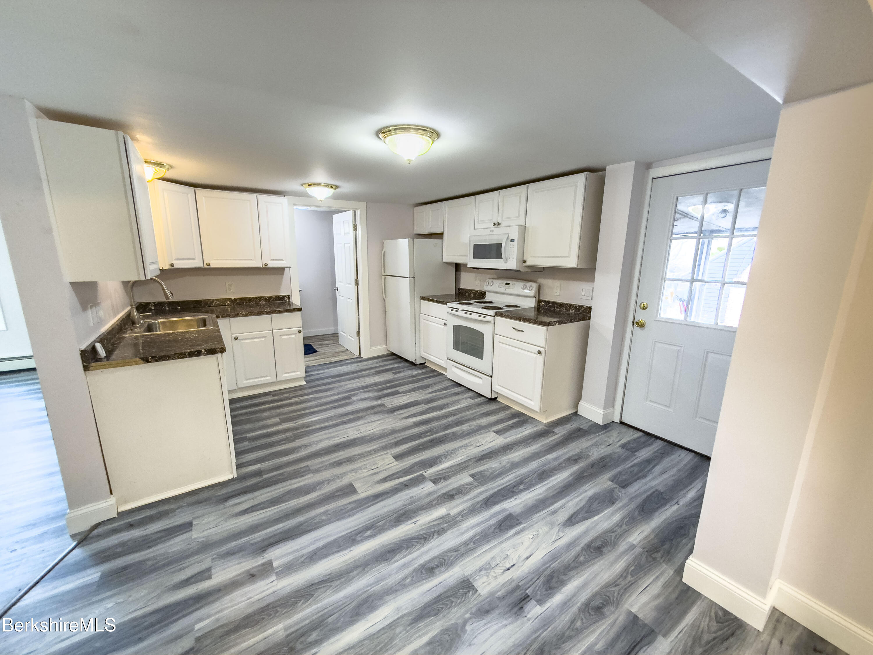 10 Enterprise Street Adams, MA 01220 - Photo 3 of 14 a kitchen with wooden floors and white appliances