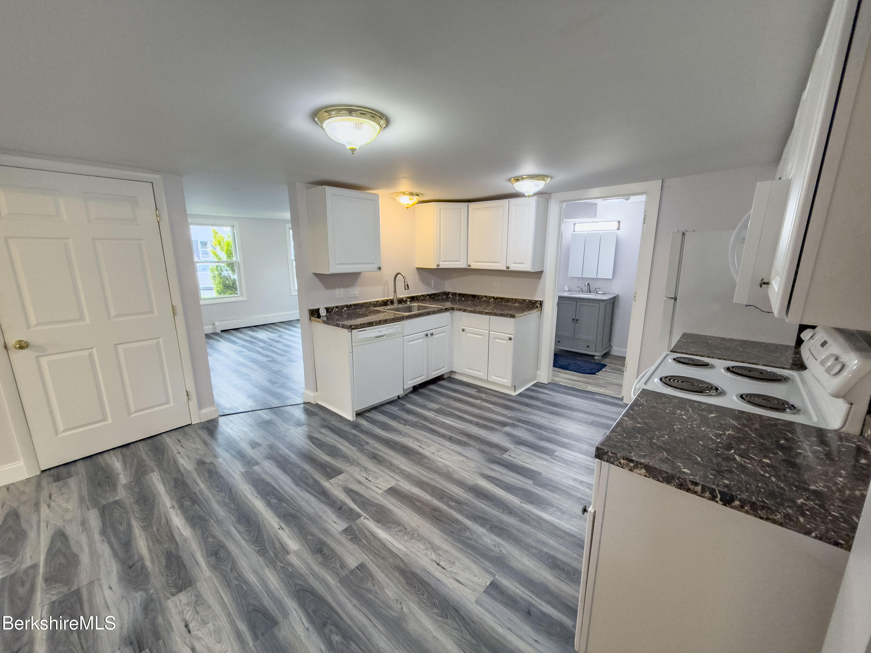 10 Enterprise Street Adams, MA 01220 - Photo 4 of 14 a large kitchen with granite countertop a sink and a stove top oven