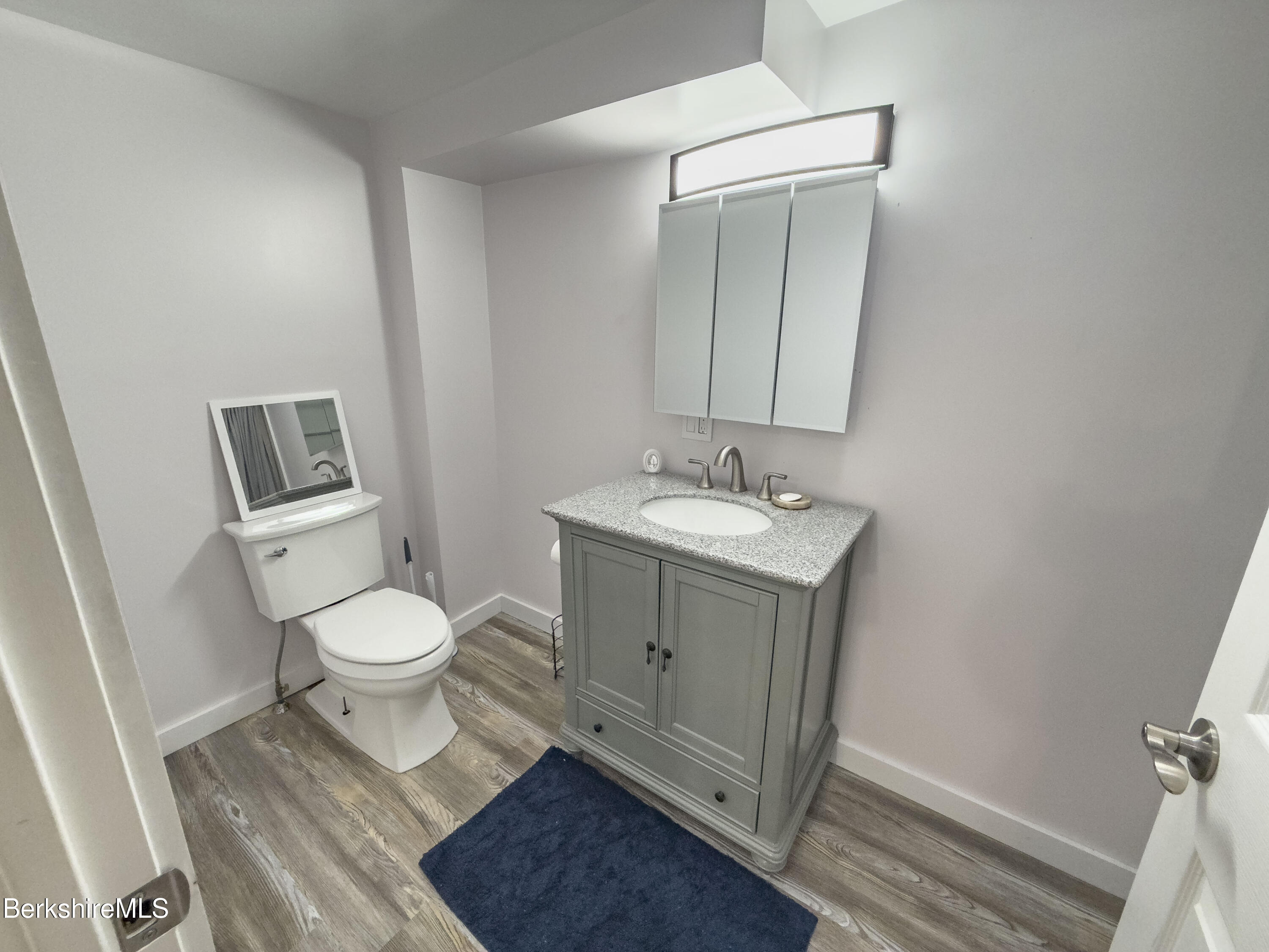 10 Enterprise Street Adams, MA 01220 - Photo 7 of 14 a bathroom with a toilet a sink a vanity and mirror