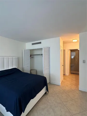 a bedroom with a bed and cabinets