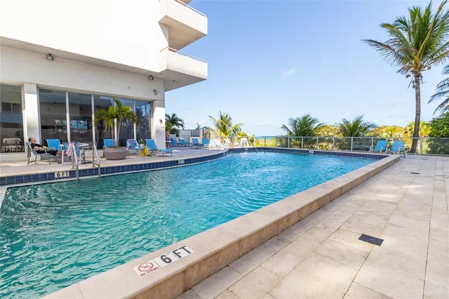 a view of a swimming pool with an outdoor seating