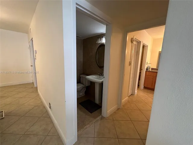 a view of a hallway and an entryway with livingroom