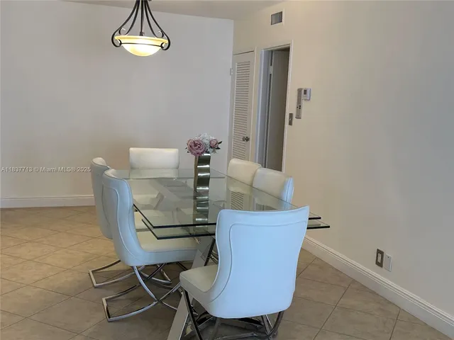 a dining room with furniture and a window