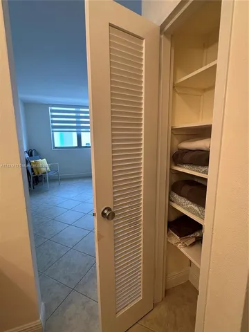 a view of an empty room and a bathroom